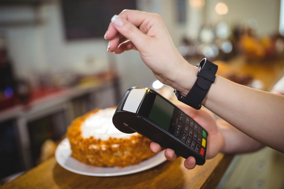 Contactless payment using smartwatch on POS terminal at bakery counter