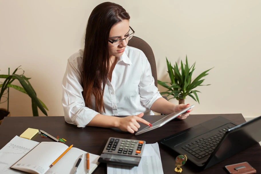 Accountant reviewing financial documents at office desk