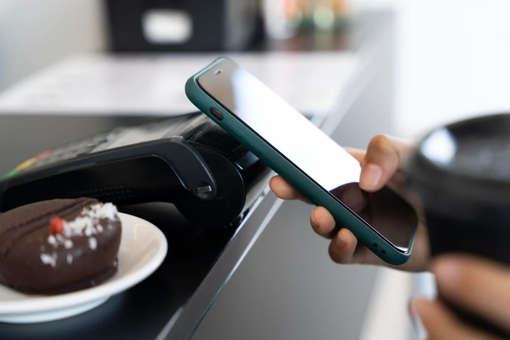 Customer using mobile phone to make a contactless payment