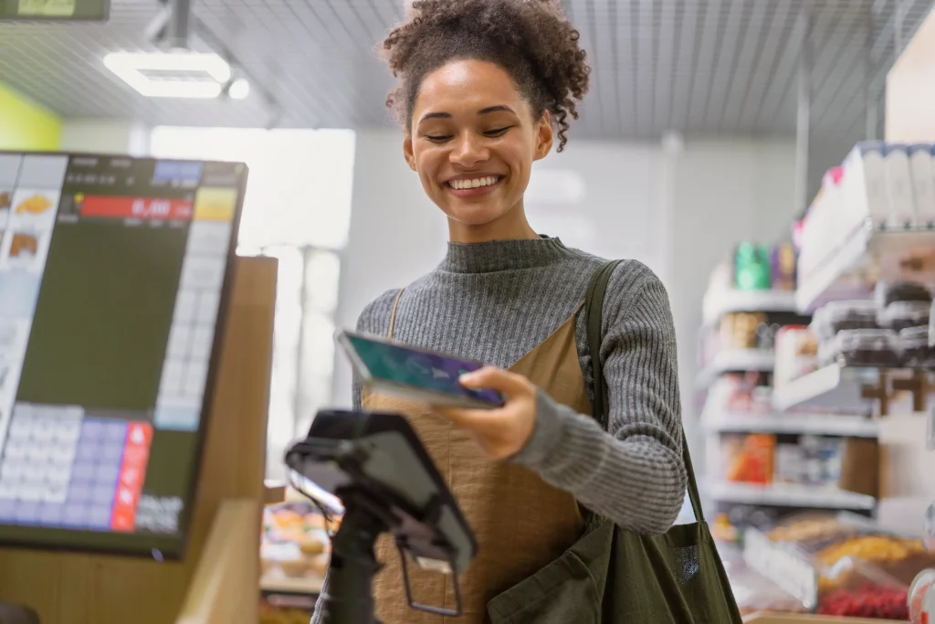 Woman making a contactless payment with her smartphone