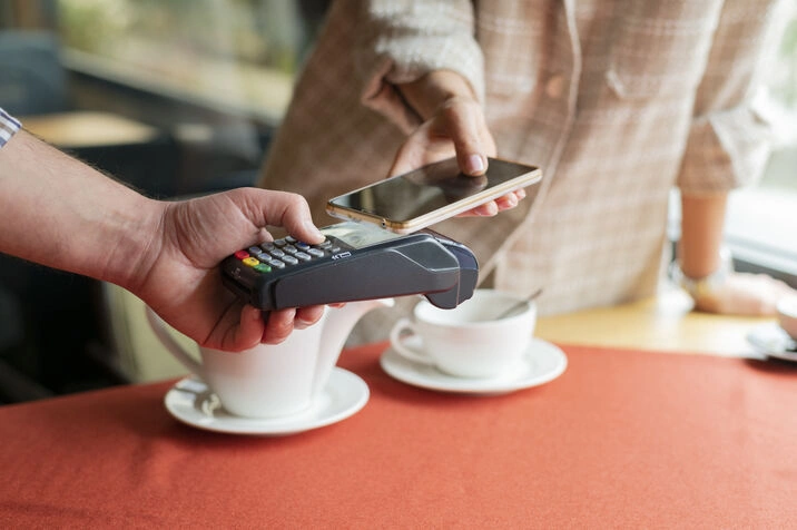 mobile payment at cafe with coffee