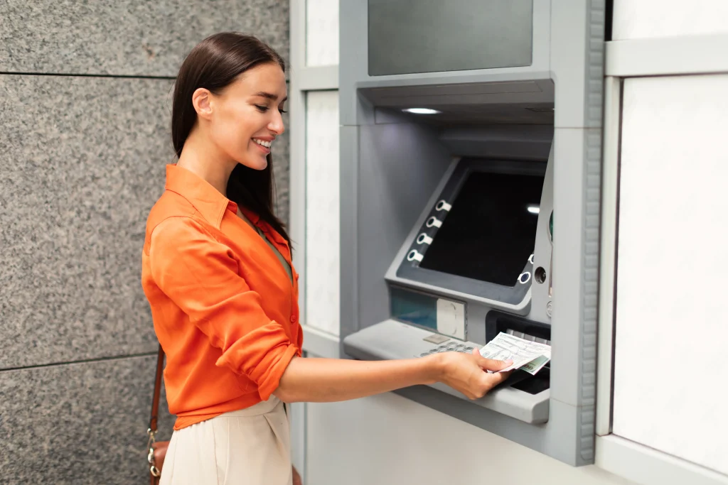 Woman using an outdoor ATM machine