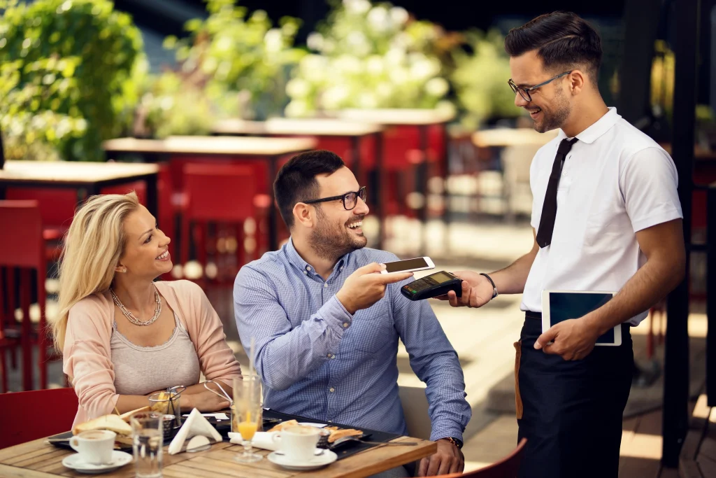 Staff using POS system in restaurant