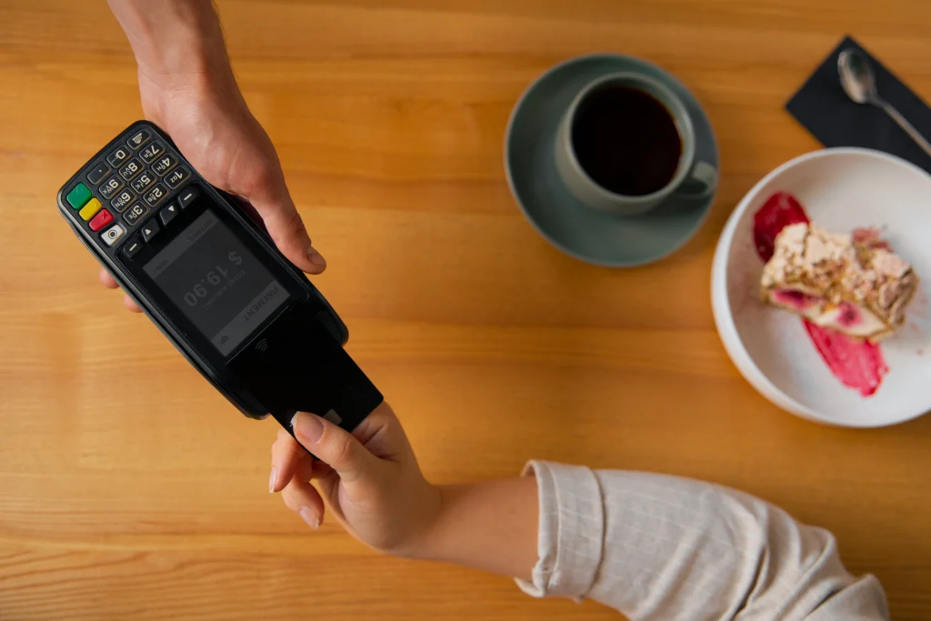 top-view-customer-paying-with-nfc-device