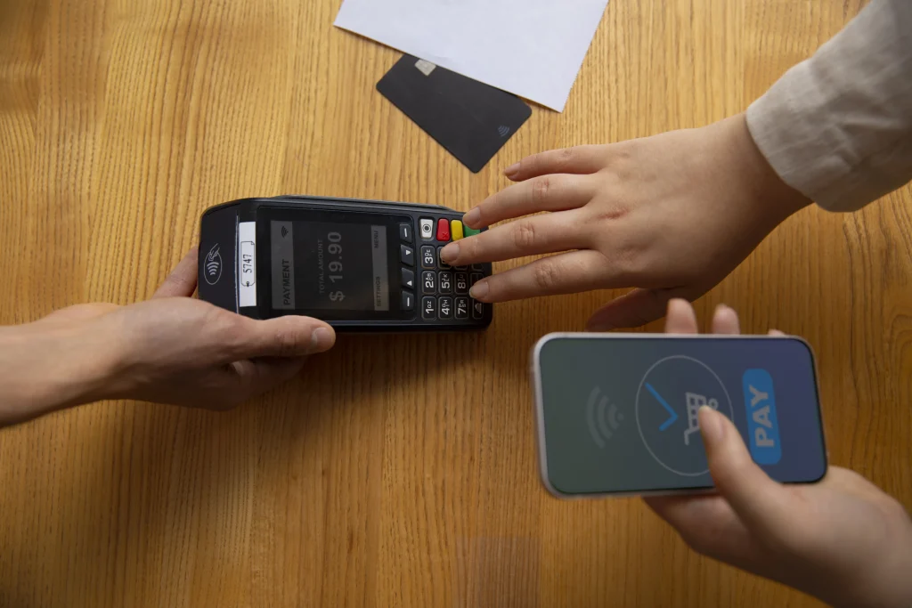 high-angle-customer-paying-with-nfc-device (1)