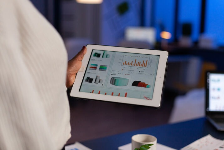 Business owner using tablet POS sales dashboard