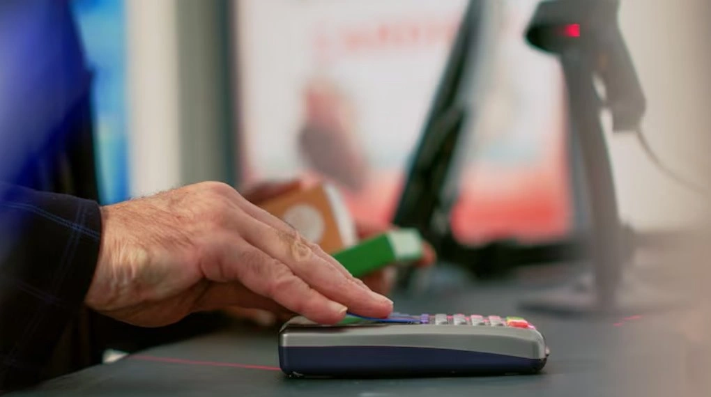 Customer making payment through secure POS terminal