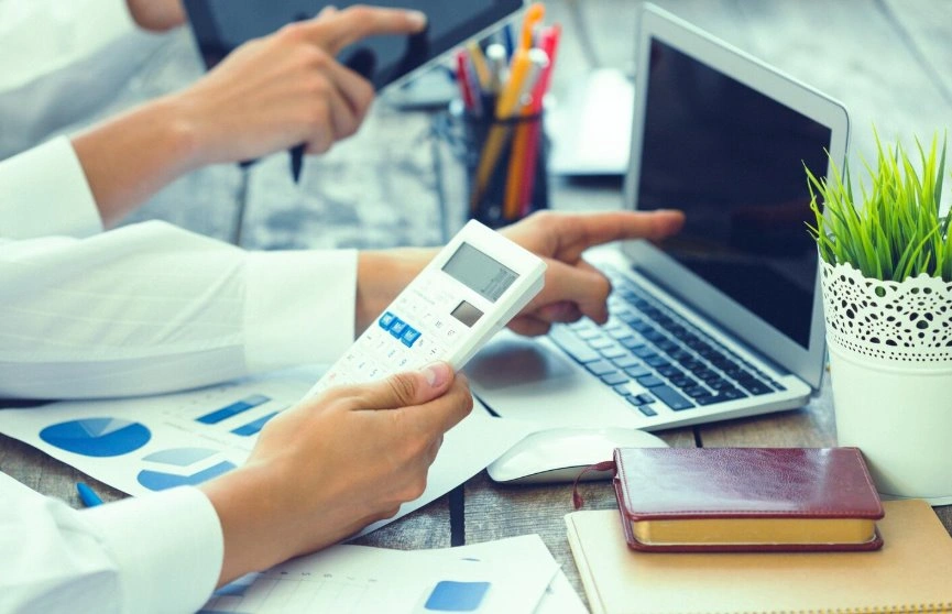Business owner calculating total POS system costs