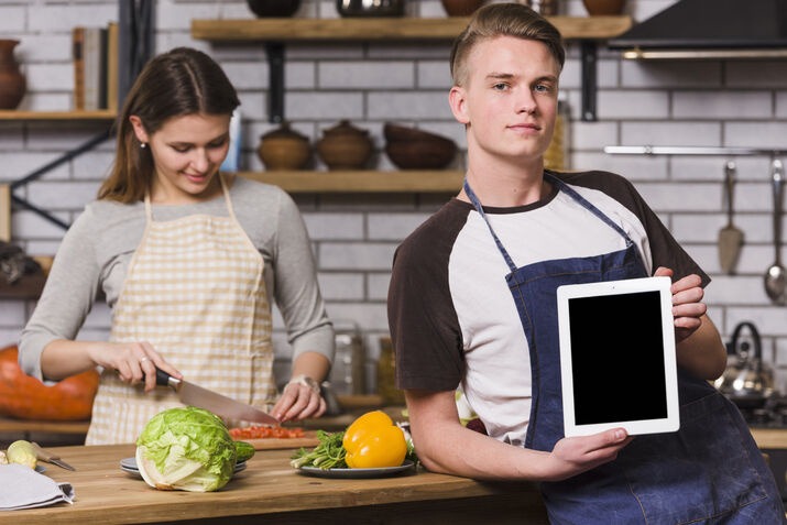 Restaurant staff using a tablet POS system to manage customer orders