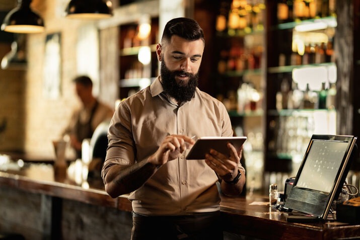 Restaurant staff using tablet POS for order management