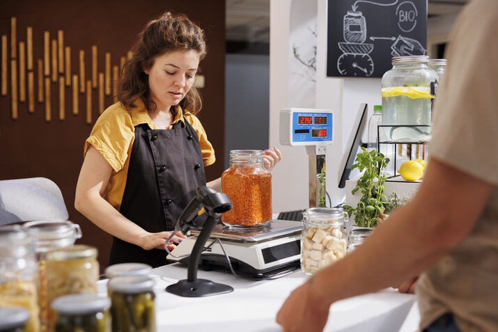 Retail cashier processing a customer payment with a modern POS system